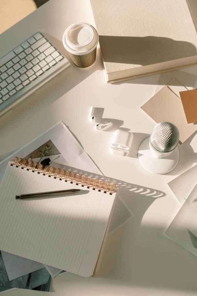 office desk with notepad, keyboard, mike and coffee